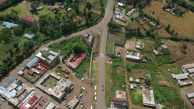 Aerial view of cars and people at a Open Air Market, in Africa - reverse, drone shot