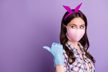 Photo portrait of girl wearing protective mask gloves pointing finger blank space isolated on bright violet color background