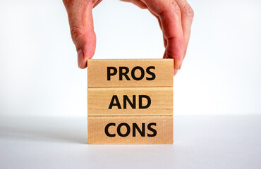 Pros and cons symbol. Wooden blocks with words 'Pros and cons'. Beautiful white background, businessman hand. Business, pros and cons concept, copy space.
