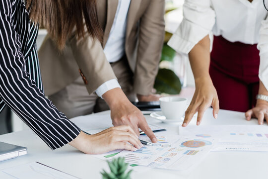 Hand of team, group young businessman,businesswoman people working marketing plan,discussing on paperwork with teamwork,colleagues at office,workplace.Brainstorm business concept.