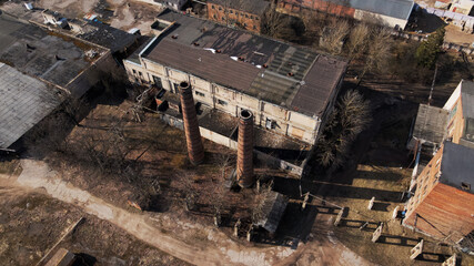 Abandoned industrial area. Old brick buildings and factory chimneys. Aerial photography.