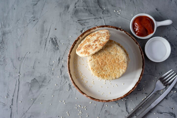 Vegetarian food: rice cakes on a white plate on a gray background