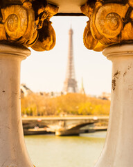 Alexander III bridge on the background unfocused Eiffel tower. Paris, France.