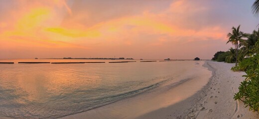Panorama View of Beautiful Sunset Sky in Maldives. Sandy Beach with Colorful Sky and Laccadive Sea on Maldivian Island.