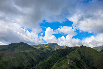 Green mountains panorama under cloudy sky spectacular landscape. Rural land scenery. Summer travel hiking in green hills. Untouched nature parkland. Volcanic island relief