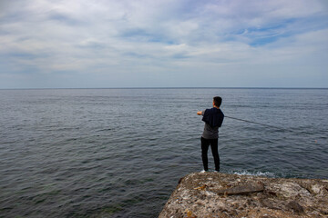 Boy fishing in the sea
