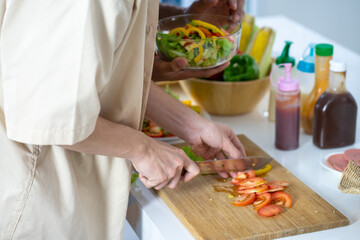 Asian young men lover LGBTQ cooking in the kitchen work from home 