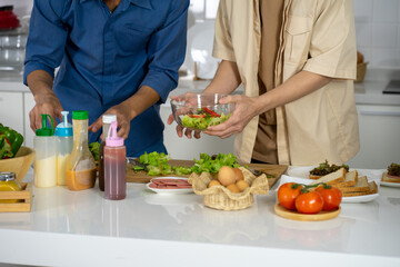 Asian young men lover LGBTQ cooking in the kitchen work from home 