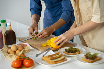 Asian young men lover LGBTQ cooking in the kitchen work from home 