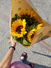 person holding a bouquet of sunflowers