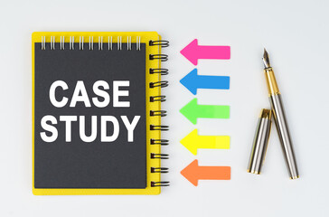 On a white background lies a pen, arrows and a notebook with the inscription - CASE STUDY