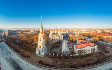 Fototapeta premium Aerial top view to St. Nicholas Naval Sea Cathedral in sunny day. Panorama of evening historical city center. Orthodox church located on banks of Kryukov and Griboyedov canal. Saint Petersburg. Russia