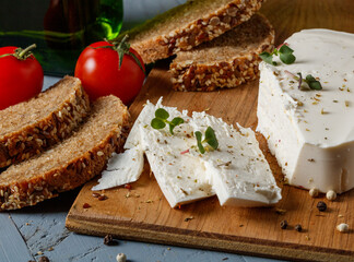 feta cheese and whole grain bread on a cutting board