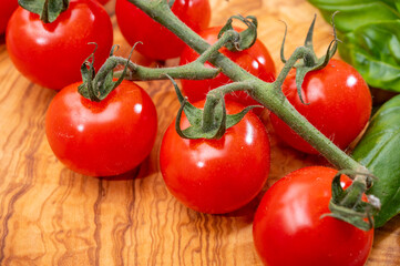 Ripe small round sweet red cherry tomatoes close up