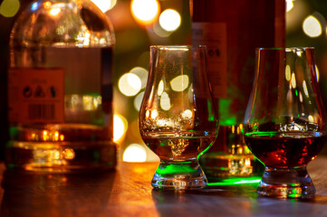 Fototapeta na wymiar Glasses of scotch whisky served in bar in Edinburgh, Scotland, UK and pasry lights on background