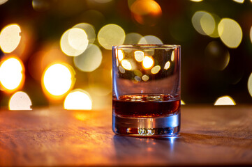 Glasses of scotch whisky served in bar in Edinburgh, Scotland, UK and pasry lights on background