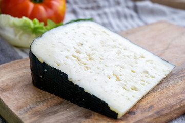 Cheese collection, French fol epi  cheese with many little holes, etorki, tomme noire des pyrenees and ossau iraty cheese