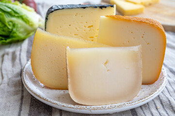 Cheese collection, French fol epi  cheese with many little holes, etorki, tomme noire des pyrenees and ossau iraty cheese