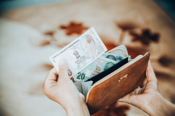 turkish lira in woman's hand