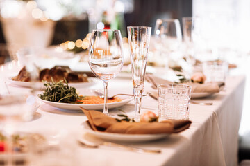 Flower table decorations for holidays and wedding dinner. Table set for holiday, event, party or wedding reception in a restaurant.