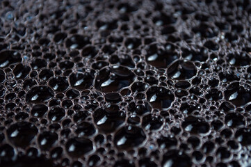 Black drop of water. Abstract background