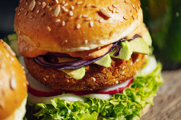 two bright fresh veggie burger without gluten and meat. burger on a gray stone background. serving burgers in a cafe or restaurant