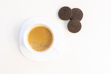 Cup of coffee on saucer with cookies isolated on white background and copy space for text