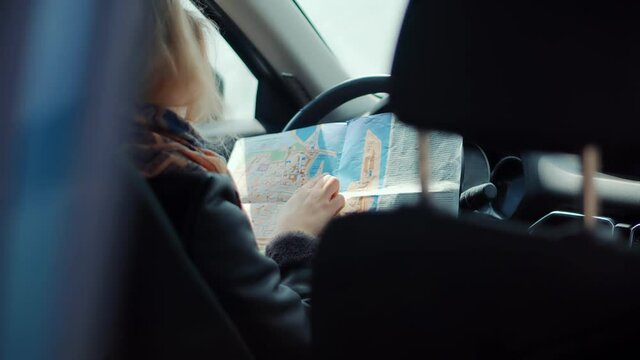 Car Traveling Sitting On Auto Looking Town Plan On Navigation Map For Journey.Woman Tourist Looking On City Paper Map And Exploring City Route.Active Lifestyle On Vacation Travel Tourism Adventure.