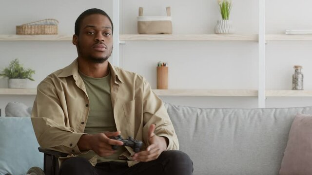 Handicapped Black Guy In Wheelchair Playing Videogame Indoor