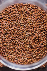 Hulled common buckwheat grains, surface and background.  Dried seeds. Food photo, close up from above.
