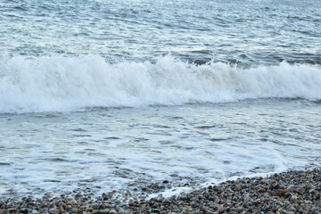a wave coming ashore on a summer evening
