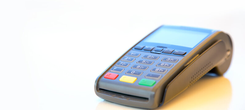Close-up machine to pay credit card. Credit card reader swipe through terminal for payment. Paying by credit card.