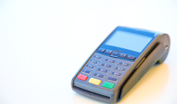 Close-up machine to pay credit card. Credit card reader swipe through terminal for payment. Paying by credit card.