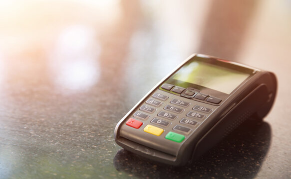 Close-up machine to pay credit card. Credit card reader swipe through terminal for payment. Paying by credit card.