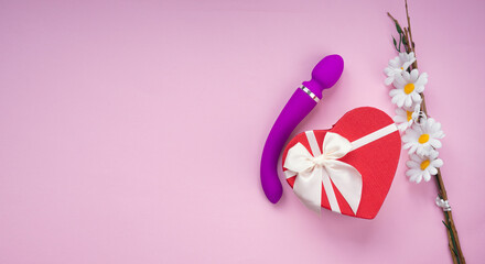 Gift box and dildo on a pink background, romantic present for adult. Purple silicone vibrator, sex toy