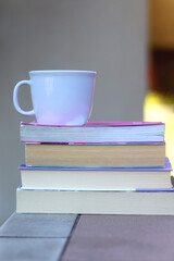 Stack of books and cup of tea or coffee. Selective focus.