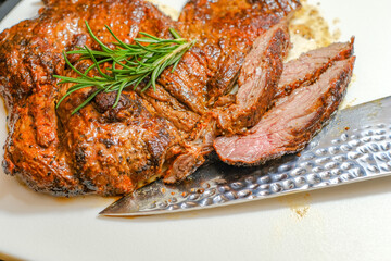 Marinated steak sliced in pieces with cilantro in a cutting board