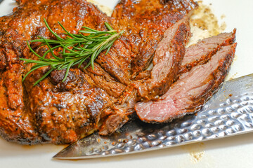 Marinated steak sliced in pieces with cilantro in a cutting board