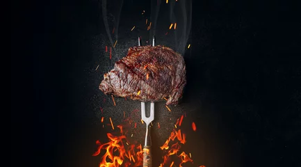 Foto op Aluminium grilled beef steak on a dark background. expensive marbled beef of the highest grade fried to rare on the grill © Mikhaylovskiy 