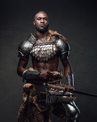 Powerful and handsome authentic soldier wearing armor with axe © Fxquadro