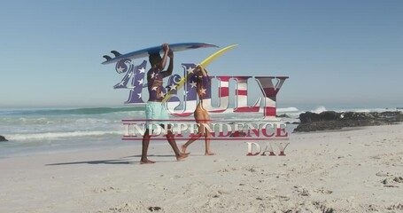 American flag waving over independence day text against couple carrying surfboards on the beach