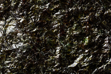 A sheet of dark green Nori seaweed in full view.