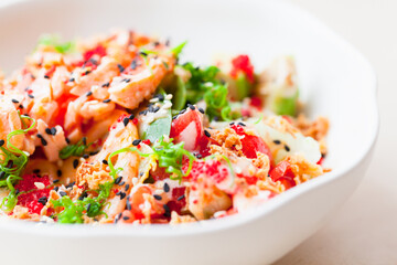Hawaiian dish. Poke with salmon and vegetables. Close up