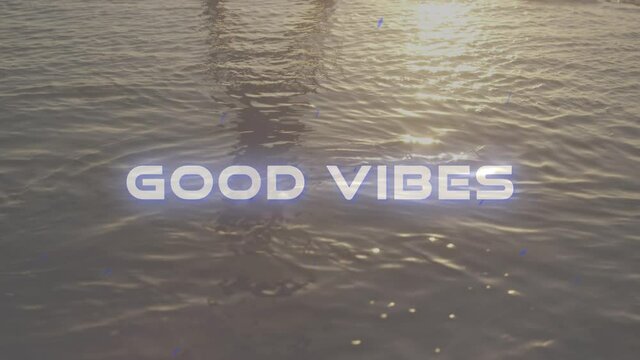 Animation of the words good vibes written in white letters over tranquil moving water