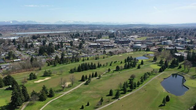 Cinematic aerial drone clip of Northwest Everett, Bayside, Port Gardner, Naval Station Everett, Legion Memorial Golf Course, bedroom communities North of Seattle by Puget Sound in Washington