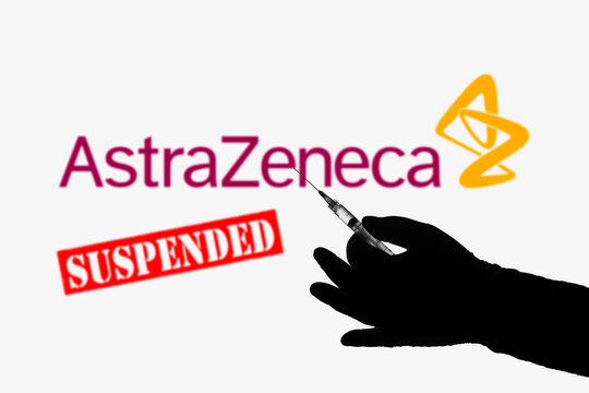 April 8, 2021, Brazil. In this photo illustration the medical syringe is seen with AstraZeneca (Suspended) company logo displayed on a screen in the background.