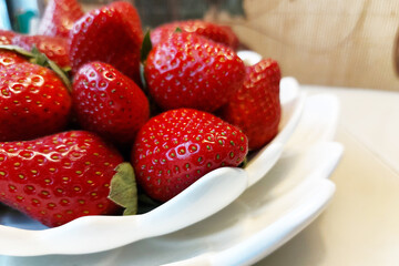 Ripe red large strawberries on a plate