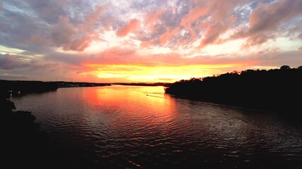 sunset on the oiapoque river amapa amazon rainforest with boat in landscape bridge binational filmed with sony A7iii