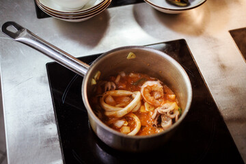 Seafood soup preparation process. Tom Yam or Bouillabaisse on induction cooker.