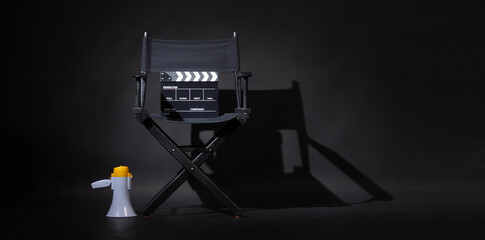 Black director chair and Clapper board or movie Clapperboard with megaphone on black background.use...